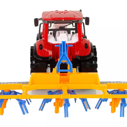 Raudonas traktorius su grėbliu