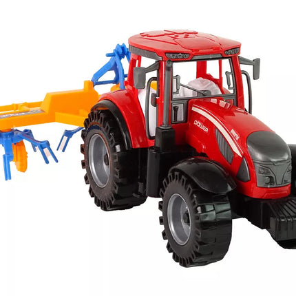 Raudonas traktorius su grėbliu