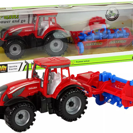 Raudonasis traktorius su plūgu