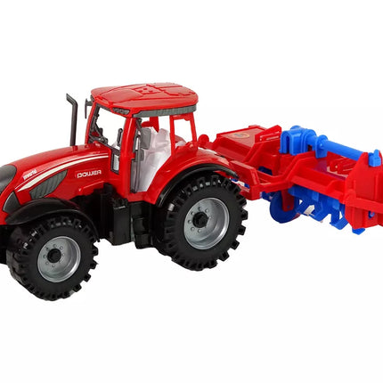 Raudonasis traktorius su plūgu