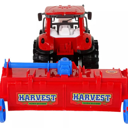 Raudonasis traktorius su plūgu