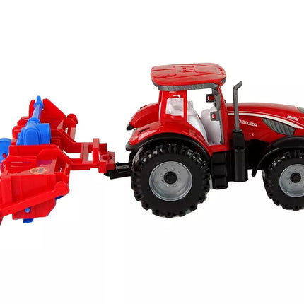 Raudonasis traktorius su plūgu