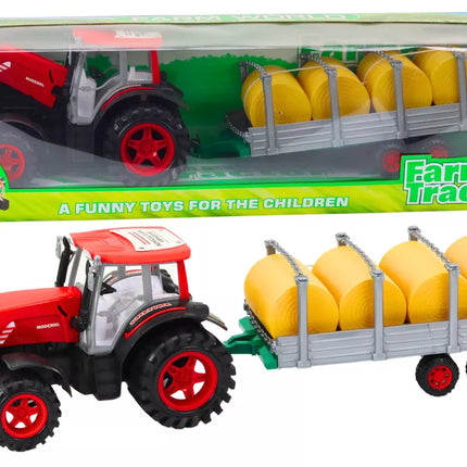 Didelis raudonas žemės ūkio traktorius su priekaba