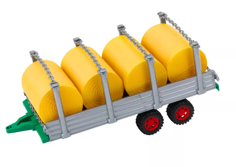 Didelis raudonas žemės ūkio traktorius su priekaba