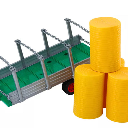 Didelis raudonas žemės ūkio traktorius su priekaba