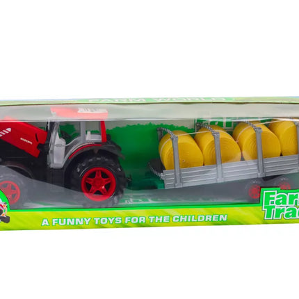 Didelis raudonas žemės ūkio traktorius su priekaba