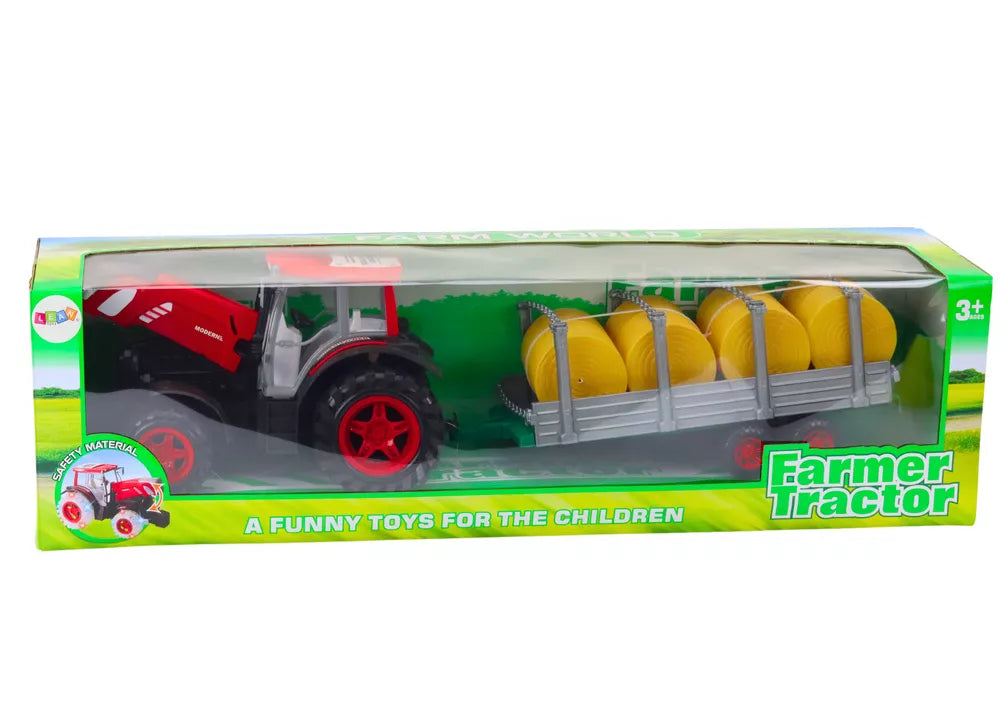 Didelis raudonas žemės ūkio traktorius su priekaba