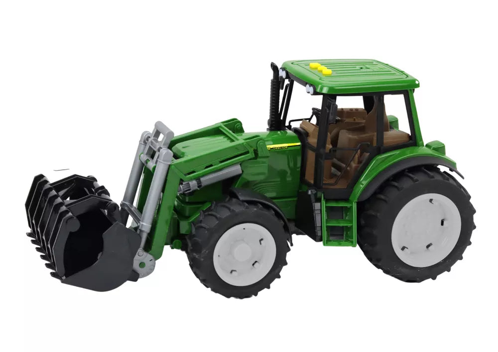 Žalias ūkio traktorius su kaušu