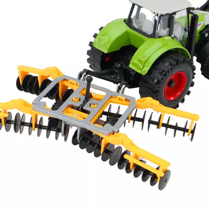 Žalias žemės ūkio traktorius su diskinėmis akėčiomis