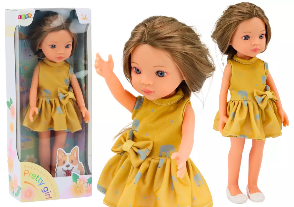 Lėlė su geltona suknele ir rudais plaukais 33 cm