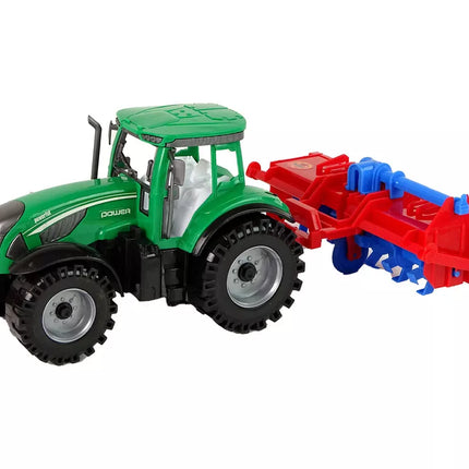 Raudonas traktorius su plūgu