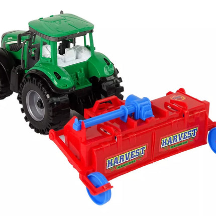 Raudonas traktorius su plūgu