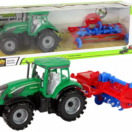 Raudonas traktorius su plūgu