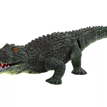 Nuotoliniu būdu valdomas krokodilas su žibintuvėliu